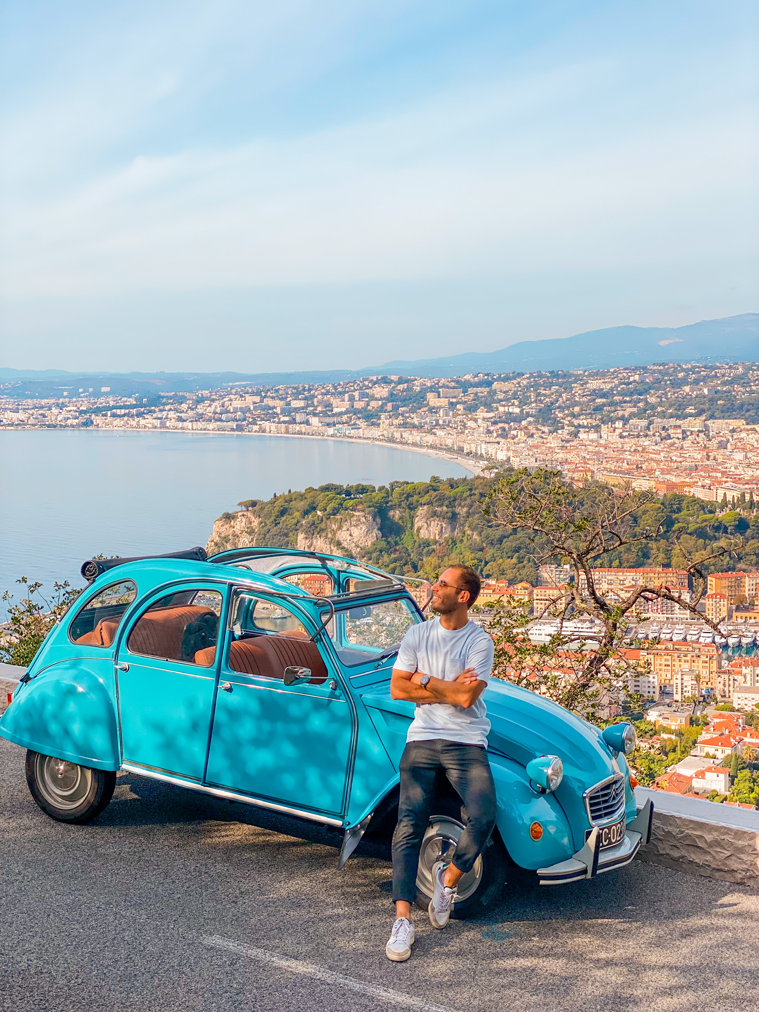 Man standing in front of 2CV Citroën car in Nice