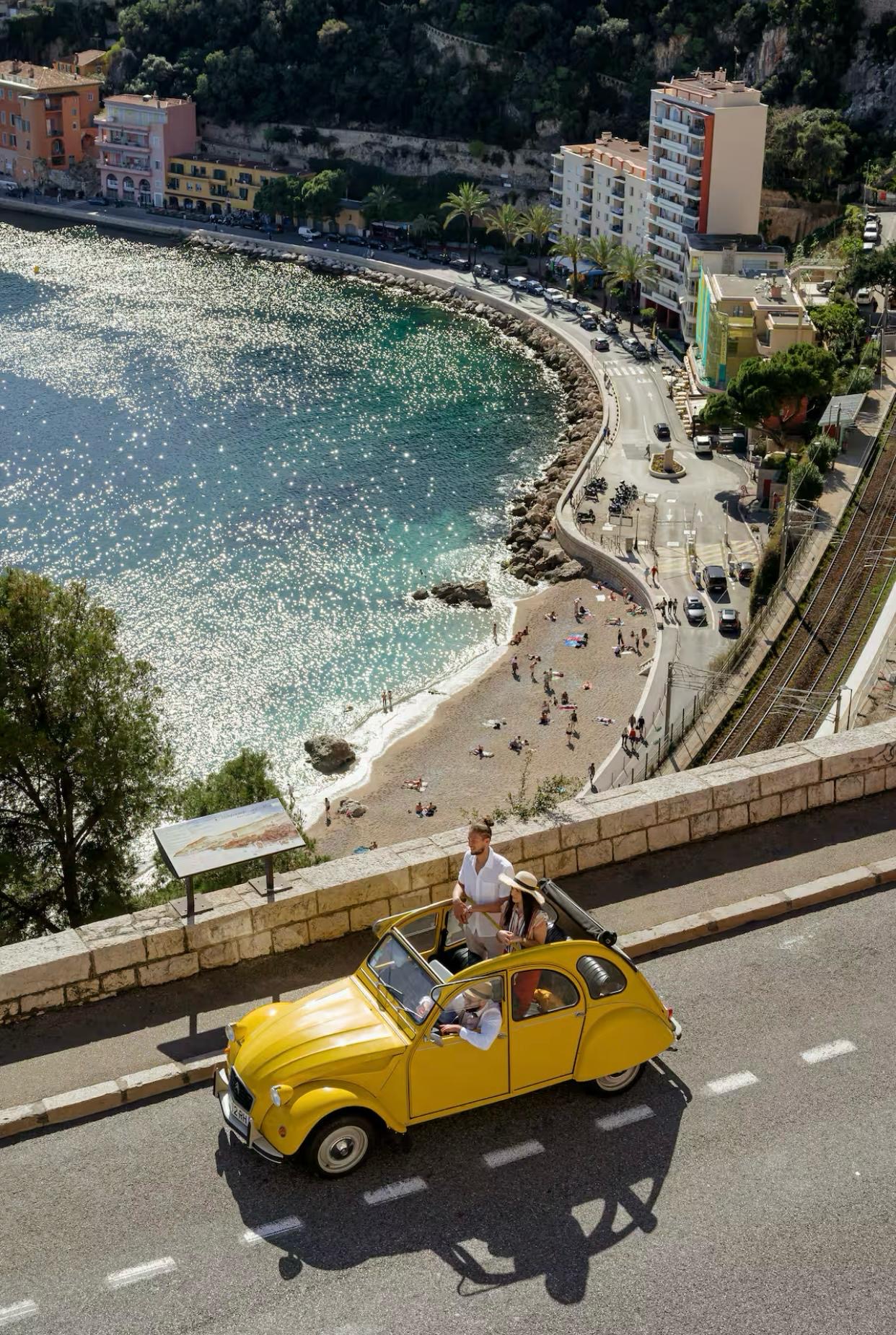 Overview of Villefranche-sur-mer with old french vintage car with travellers