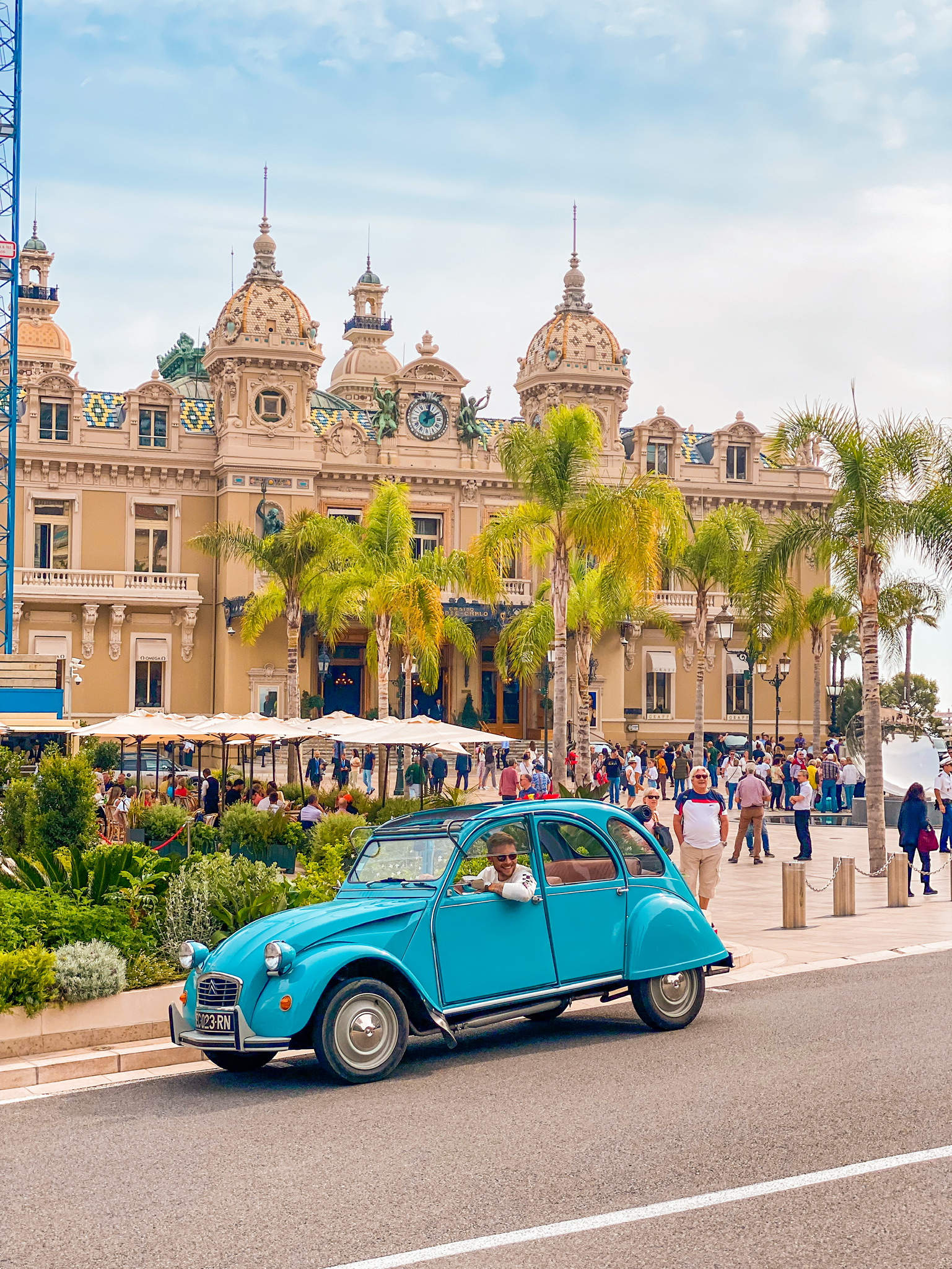 View of Monaco Monte Carlo Casino with Old French Vintage 2CV car with driver