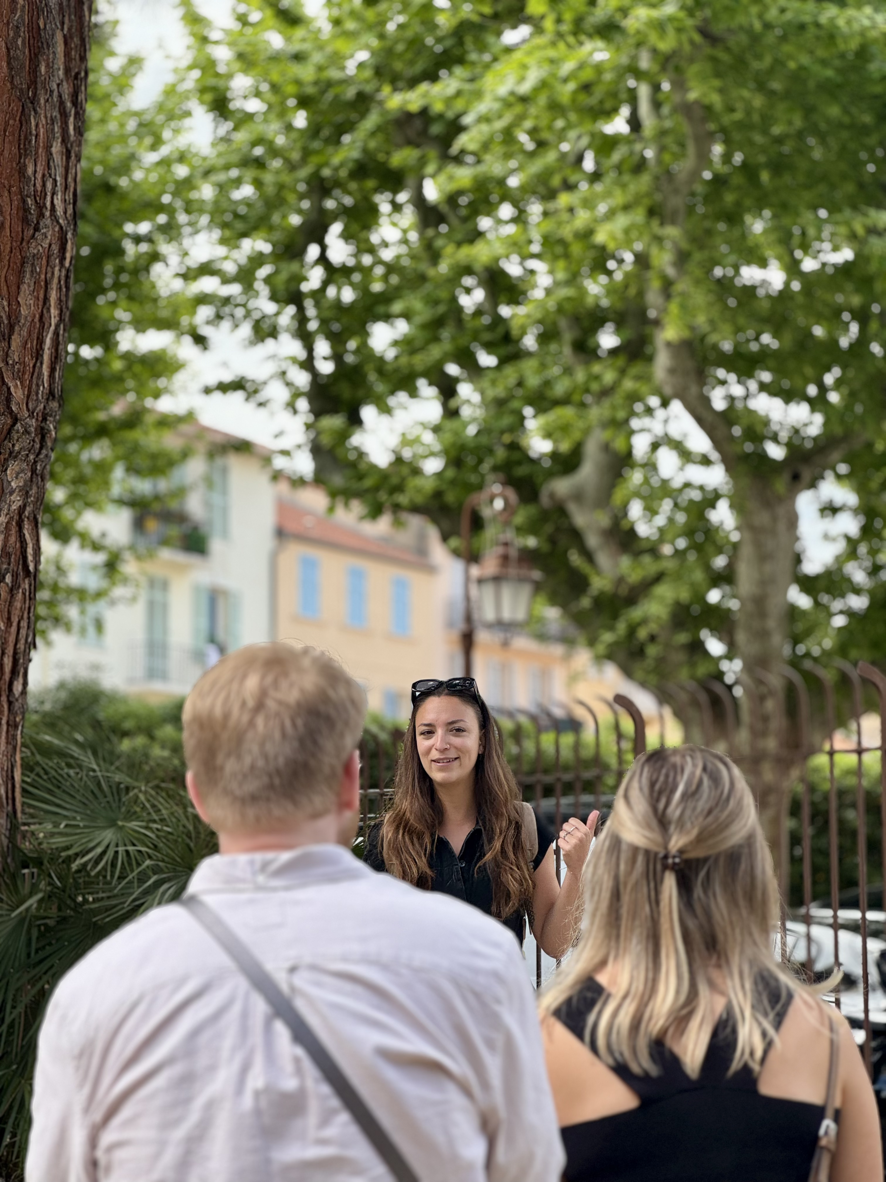Ysa Tour Guide in front of giant wall painting in Cannes