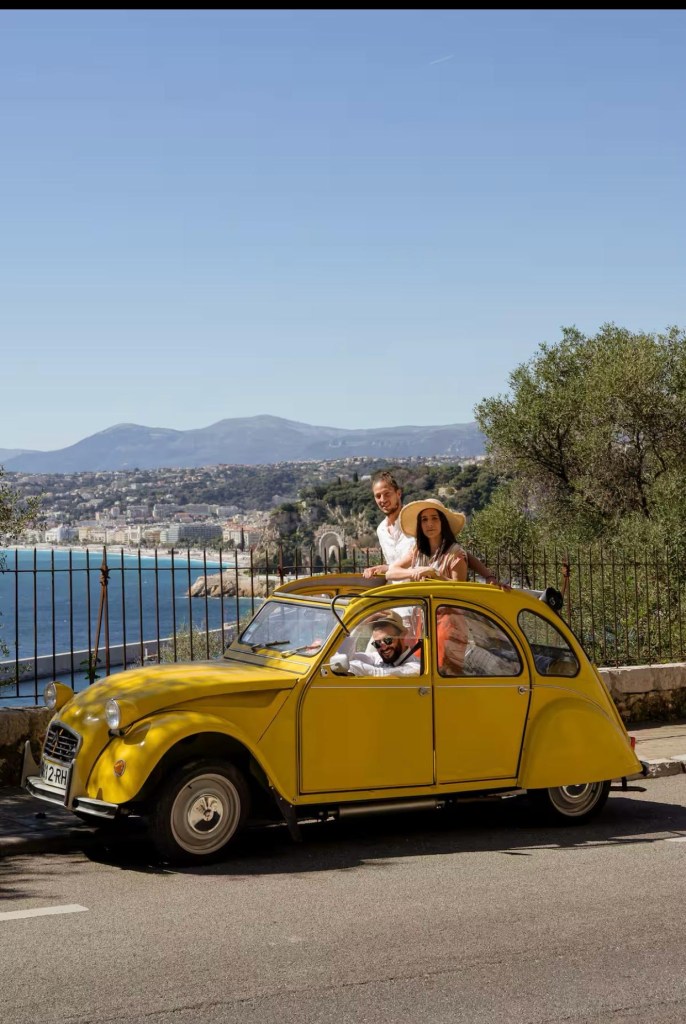 couple in citroen 2cv corniche drive Nice